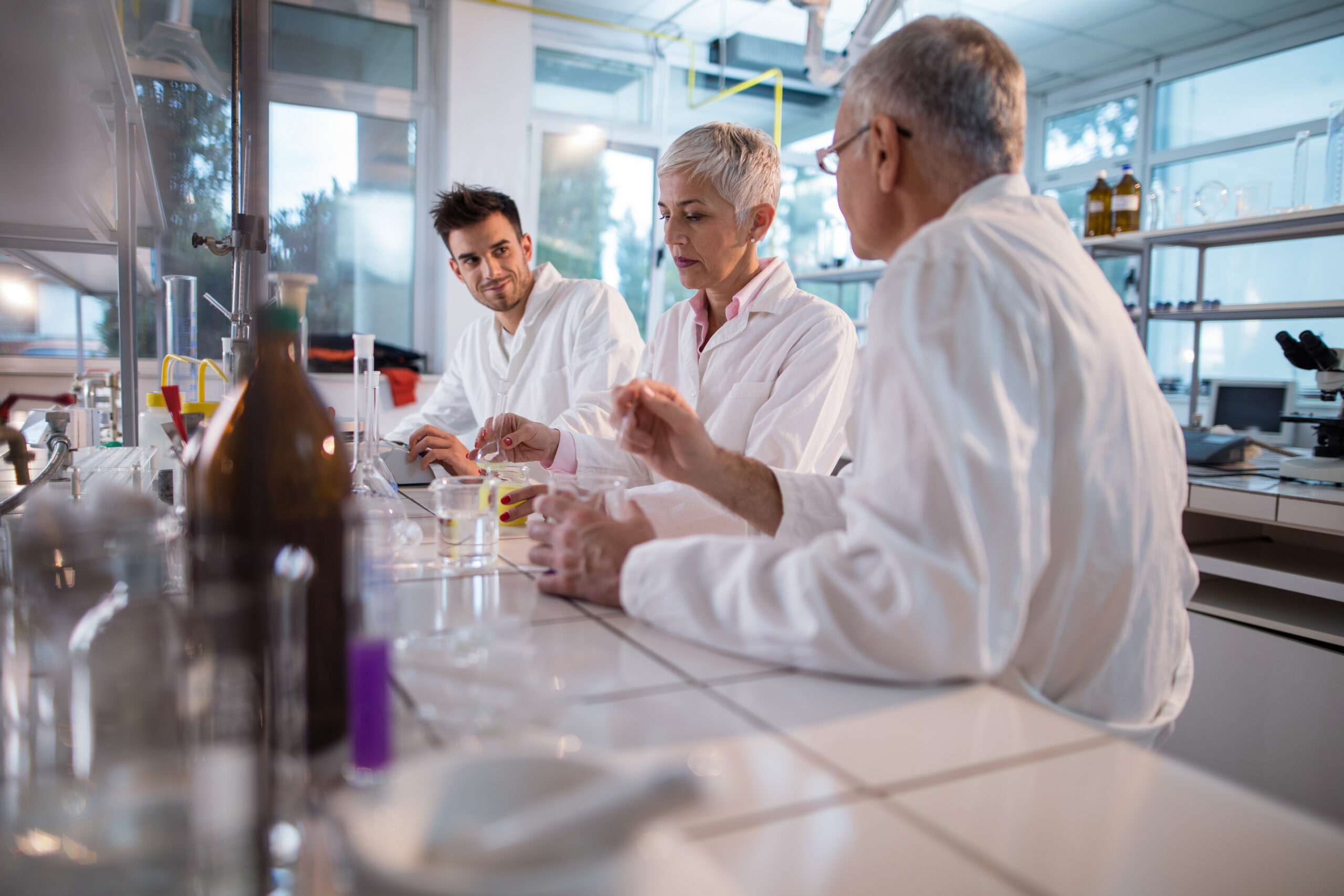 Group of chemists working on a research in laboratory.